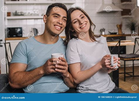 Cheerful Interracial Couple Holding Cups Of Stock Image Image Of