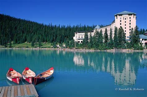 Canoes Wait For Tourists Near The Chateau Lake Louise Hotel Lake