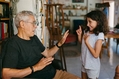 Grandfather And Granddaughter Joking At Home By Stocksy Contributor