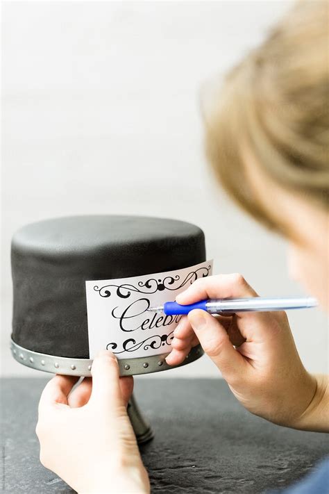 Woman Impressing Design Onto Chalkboard Cake By Stocksy Contributor Kirsty Begg Stocksy