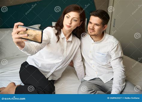 Young Couple Takes Selfie On The Bed In Hotel Room Stock Image Image Of Young Girlfriend