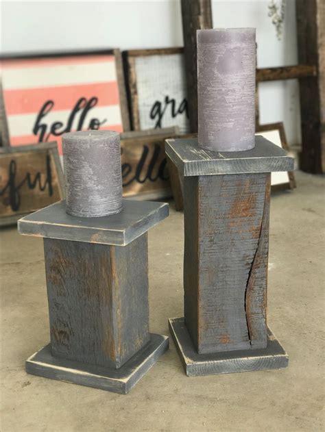 Two Wooden Candlesticks Sitting Next To Each Other
