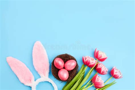 Pink Easter Eggs In A Nest A Bouquet Of Tulips And Bunny Ears Stock