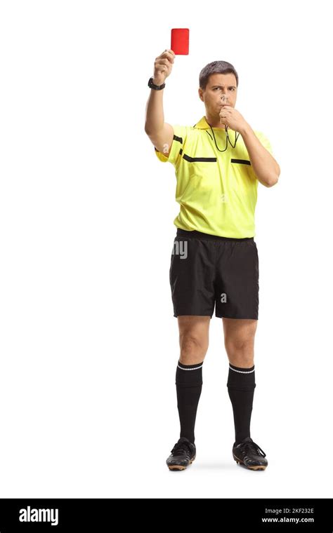 Full Length Portrait Of A Football Referee Blowing A Whistle And