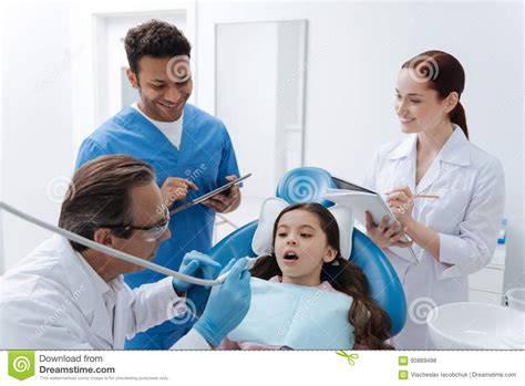 Scared Girl Looking At Her Dentist Stock Photo Image Of Learn