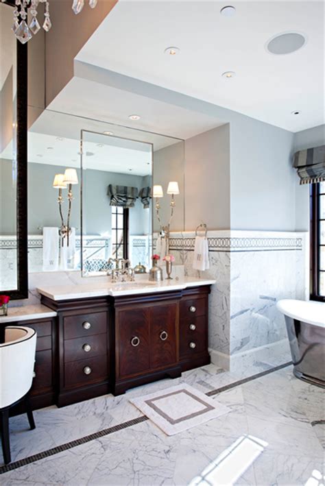 Sophisticated bathroom features nook filled with an curved vanity in an espresso finish topped with contrasting white marble countertop under an espresso framed vanity mirror lit by chic sconces flanked by floor to ceiling. Espresso Bathroom Cabinets - Transitional - bathroom ...