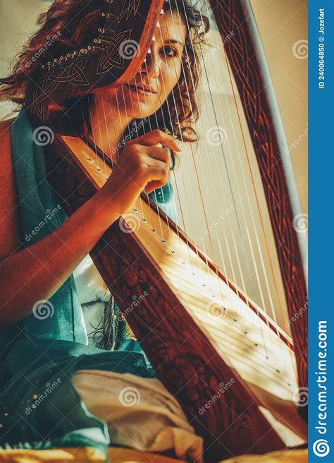 Woman With A Harp Beautiful Girl Harpist Playing Her Instrument Stock