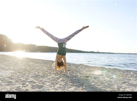 Young Girl Doing Handstand On The Beach Stock Photo Alamy