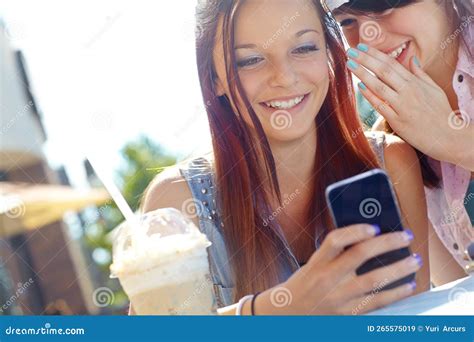 Sharing A Naughty Text A Teenage Girl Texting On A Cellphone While Her