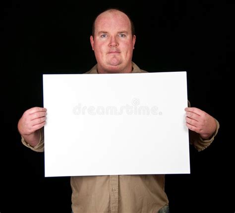 Man Holding An Blank Paper Over A Black Background Stock Photo Image
