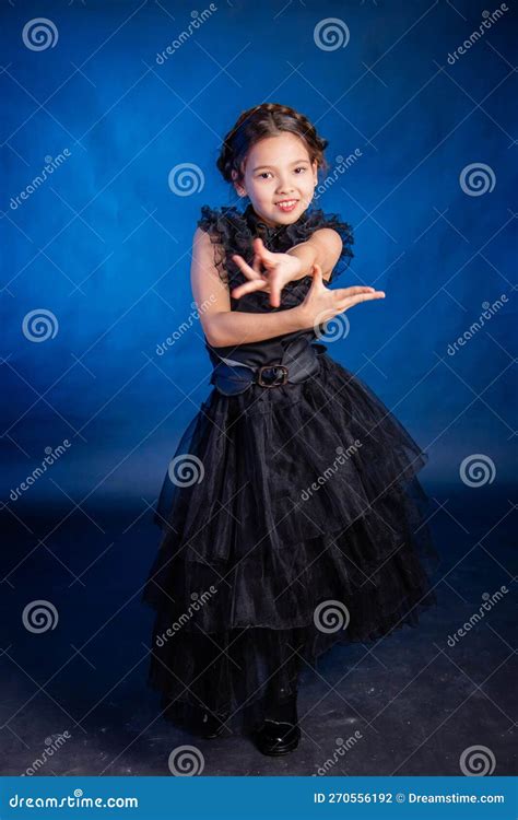 A Little Girl In A Black Dress With A Pigtail Hairstyle On Her Head