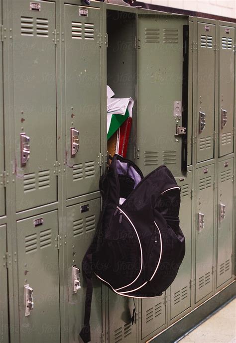 Backpack Hangs From Open Messy Locker In School Hallway By Tana Teel