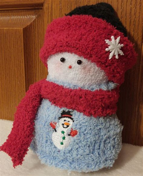 A Stuffed Snowman Wearing A Red Hat And Scarf
