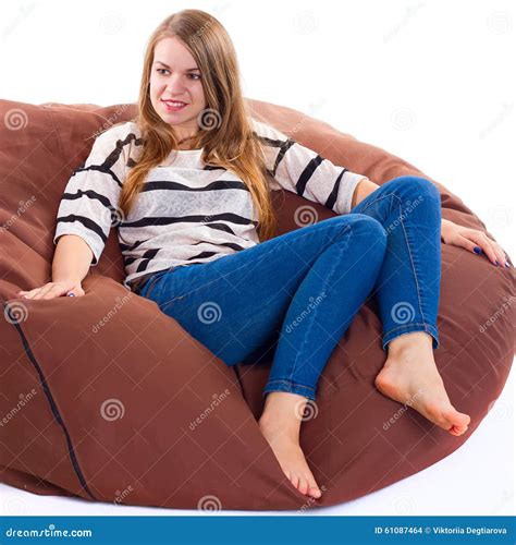 Girl Sitting On A Braun Beanbag Chair Royalty Free Stock Photo