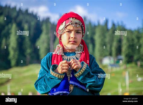 A Girl Dressed In A Traditional Kashmiri Dress Poses For A Photo On A