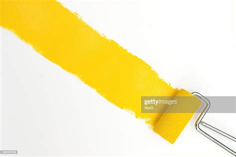 Single Streak Of Yellow Paint With Rollers Over White High Res Stock