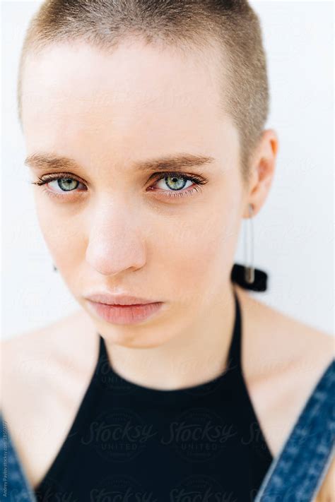 close up portrait of a stylish woman with crewcut looking at camera by stocksy contributor