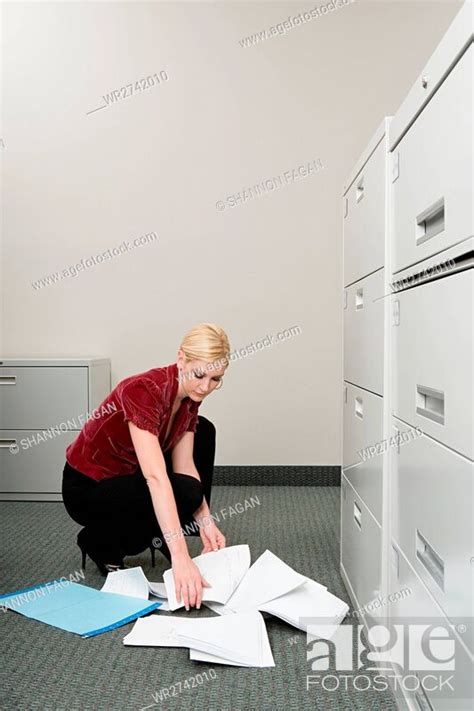Woman Picking Up Dropped Paper Stock Photo Picture And Royalty Free