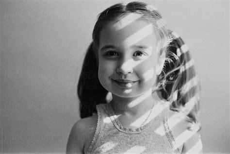 Black And White Portrait Of Beautiful Young Girl With Light Shadows On