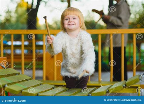 Close Up Portrait Of Cute Girl Playing Xylophone Outdoor Stock Image