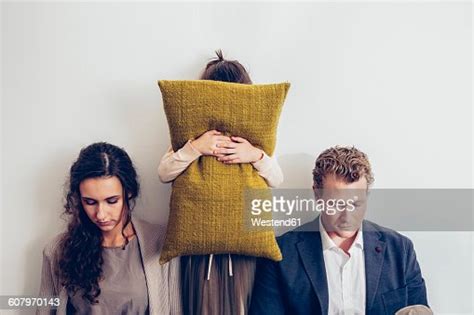 Couple Having Relationship Conflict With Their Daughter Hiding Her Face