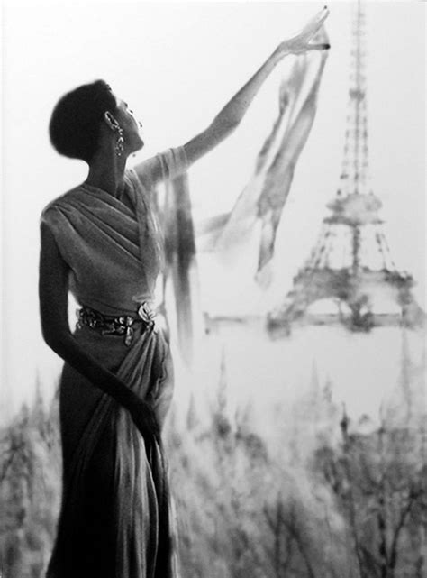 A Black And White Photo Of A Woman In Front Of The Eiffel Tower