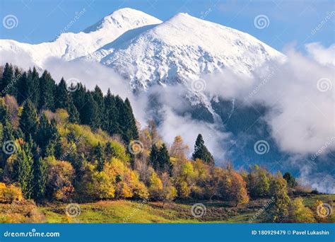 Autumn Landscape With Mountains Covered With Snow On Top And Colorful
