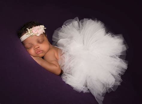 African American Newborn Baby Girl Sleeping In White Puffy Tutu