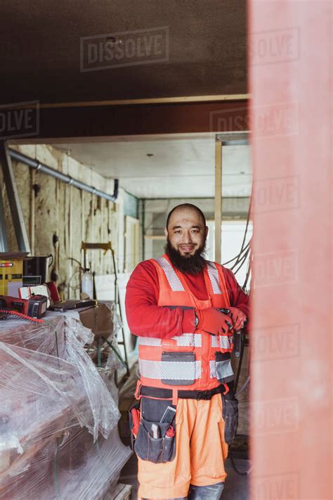 Smiling Bearded Construction Worker Working At Site Stock Photo