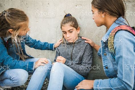 Girl Problem At School Sitting And Consoling Child Each Other Stock
