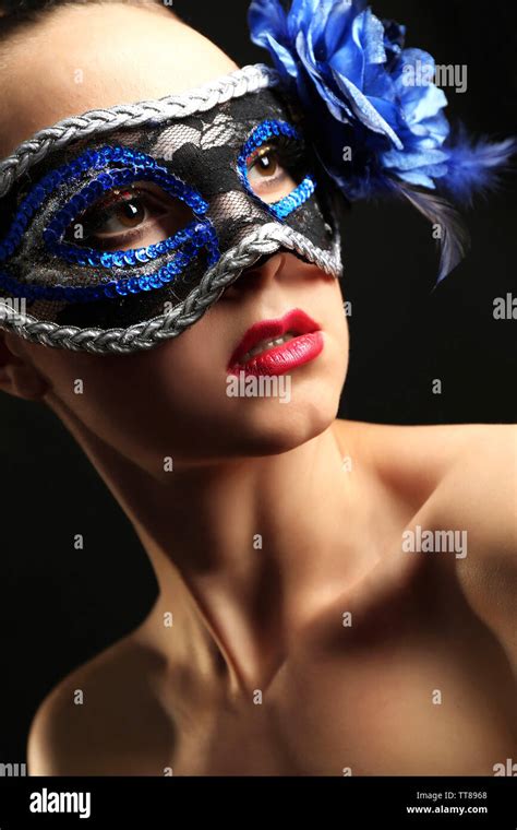 Portrait Of Beautiful Woman With Fancy Glitter Makeup And Masquerade Mask On Dark Background