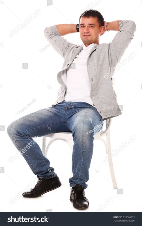 Young Caucasian Handsome Man Sitting On The Chair Isolated Over White