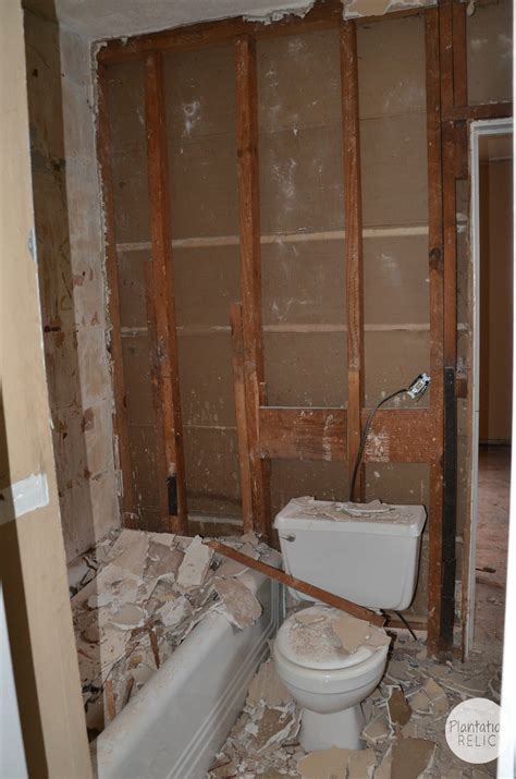 Carefully place the pry bar between the wall and the tub and pull it away from the wall. Crazy Old Houses! What We Found During Demo of the Bathroom