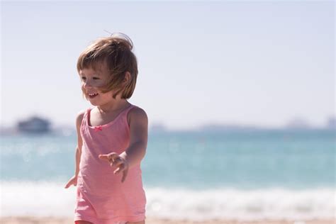 Premium Photo Happy Little Girl At The Seaside In The Summeradorable