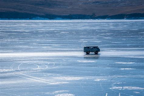 Car Driving On Natural Breaking Ice In Frozen Water At Lake Baikal