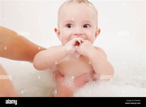 Mother Washing Baby Girl In Bubble Bath Stock Photo Alamy