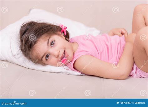 Portrait Of Cute Girl Lying On A Bed With Pacifier Stock Image Image