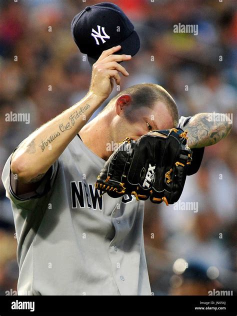 New York Yankees Pitcher A J Burnett Wipes His Brow In First
