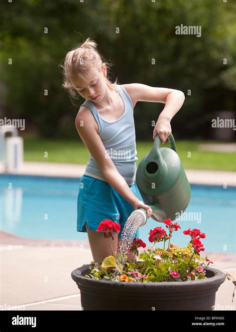 Young Girl Watering Flowers Stock Photo Alamy