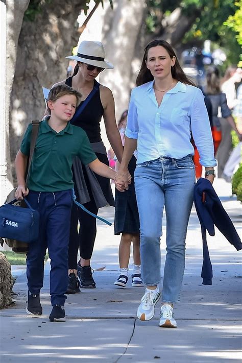 Jennifer Garner Wears A Light Blue Shirt And Jeans While Picking Up Her