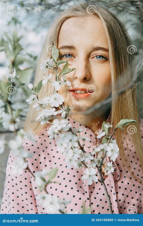 Blonde Girl On A Spring Walk In The Garden With Cherry Blossoms Female