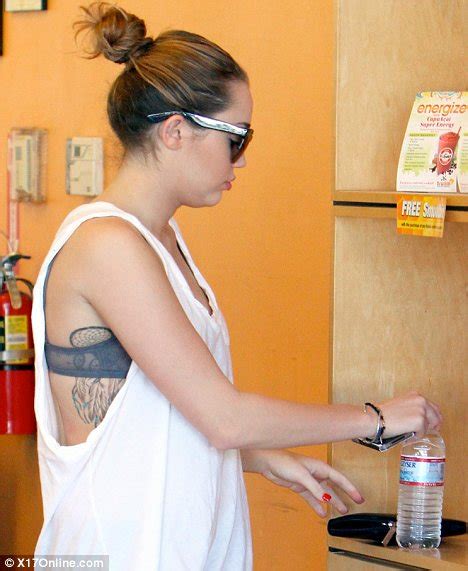 Miley Cyrus Shows Off Dream Catcher Tattoo In Low Cut Revealing White