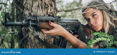 Attractive Woman Soldier Shooting With Rifle Machine Gun In Forest