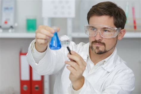 Male Scientist Researcher Conducting Experiment In Lab Stock Image