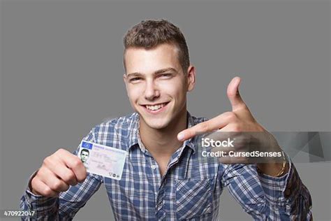 Young Man Showing Off His Driver License Stock Photo Download Image
