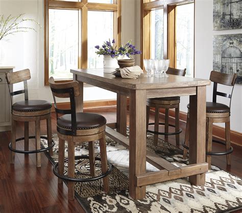 Rich dark cherry finish two faux leather swivels the cottage oak pub table set is counter height warm and inviting for dining and entertaining. Ashley Signature Design Pinnadel 5-Piece Counter Table Set ...