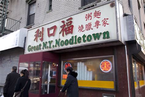 People Walk Past A Chinese Restaurant Called Great N K Noodletown