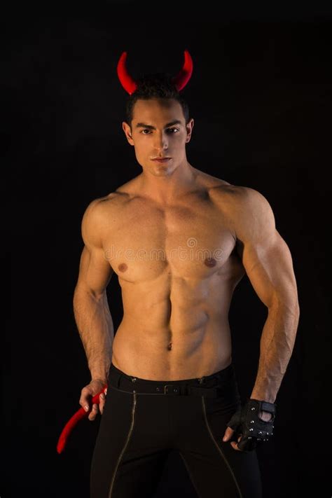 Shirtless Muscular Male Bodybuilder Dressed With Devil Costume Stock