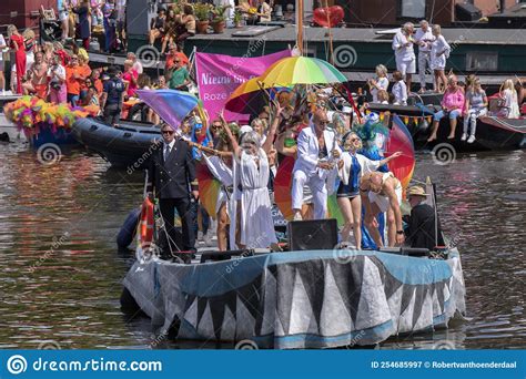 front view blond and blauw theater boat at the gaypride canal parade with boats at amsterdam the