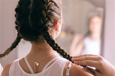 Teen Girl Braiding Hair In Mirror By Stocksy Contributor Gillian